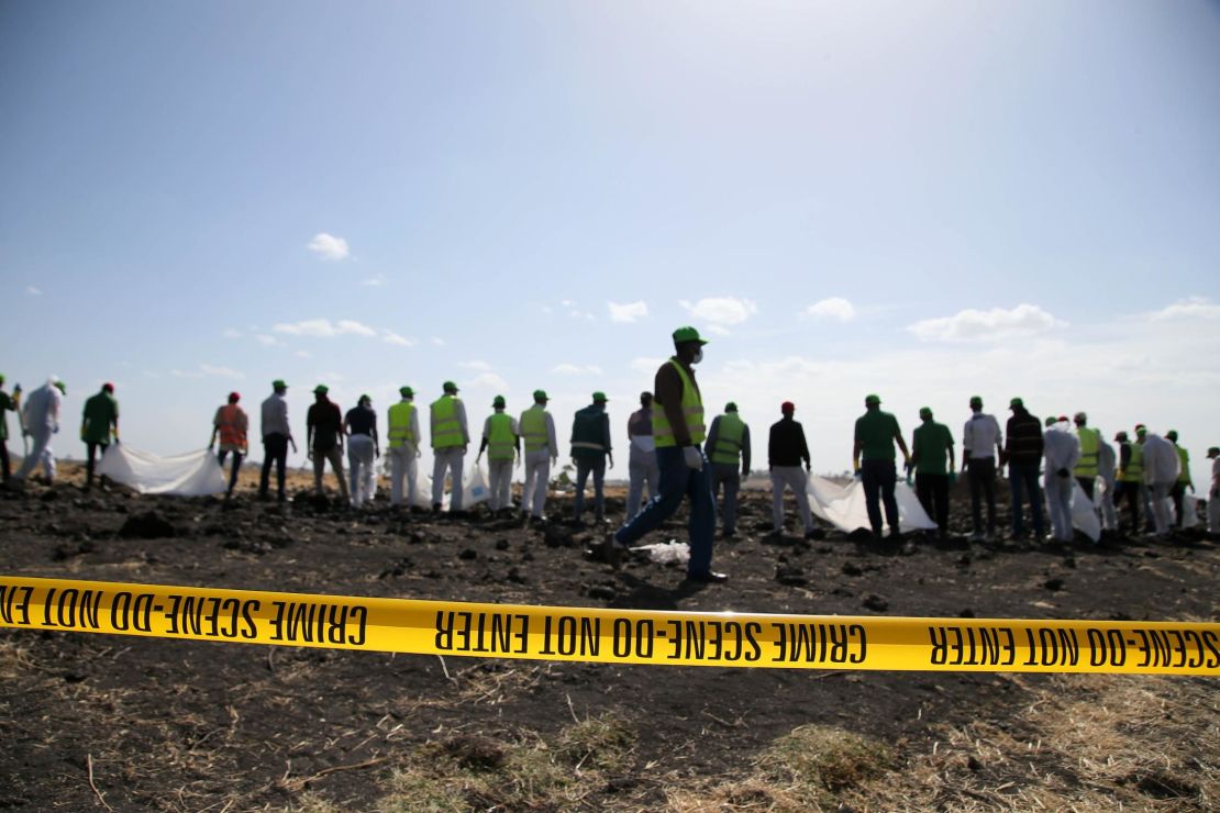 Forensics investigators and recovery teams work at the crash site near Bishoftu.  