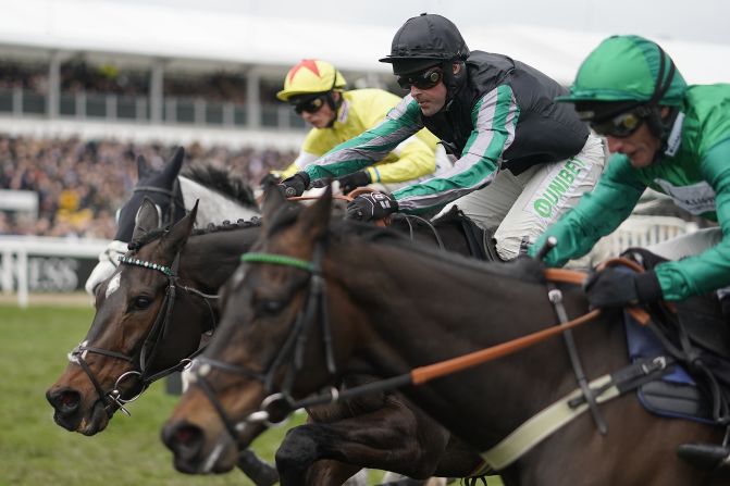 Altor (center), ridden by Nico de Boinville, made it 18 straight wins with victory in the feature race, the Queen Mother Champion Chase, on Ladies' Day Wednesday at the Cheltenham Festival.  