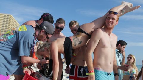 A woman drinks from a keg during spring break in March 2015 in Panama City Beach, Florida.