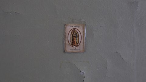 An image of the Virgin Mary adorns a wall in the damaged apartment of Miriam Montanez.