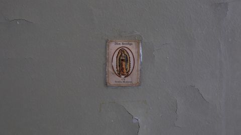 An image of the Virgin Mary adorns a wall in the damaged apartment of Miriam Montanez.