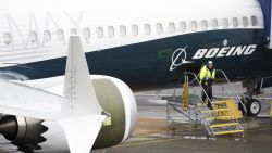 A worker is pictured next to a Boeing 737 MAX 9 airplane on the tarmac at the Boeing Renton Factory in Renton, Washington on March 12, 2019. - US President Donald Trump on March 13, 2019, announced a plan to ground all Boeing 737 MAX aircraft amid intense international and political pressure following the second deadly crash in less than five months. "We're going to be issuing an emergency order of prohibition regarding all flights of the 737 MAX 8 and 737 MAX 9," Trump told reporters the White House. (Photo by Jason Redmond / AFP)        (Photo credit should read JASON REDMOND/AFP/Getty Images)