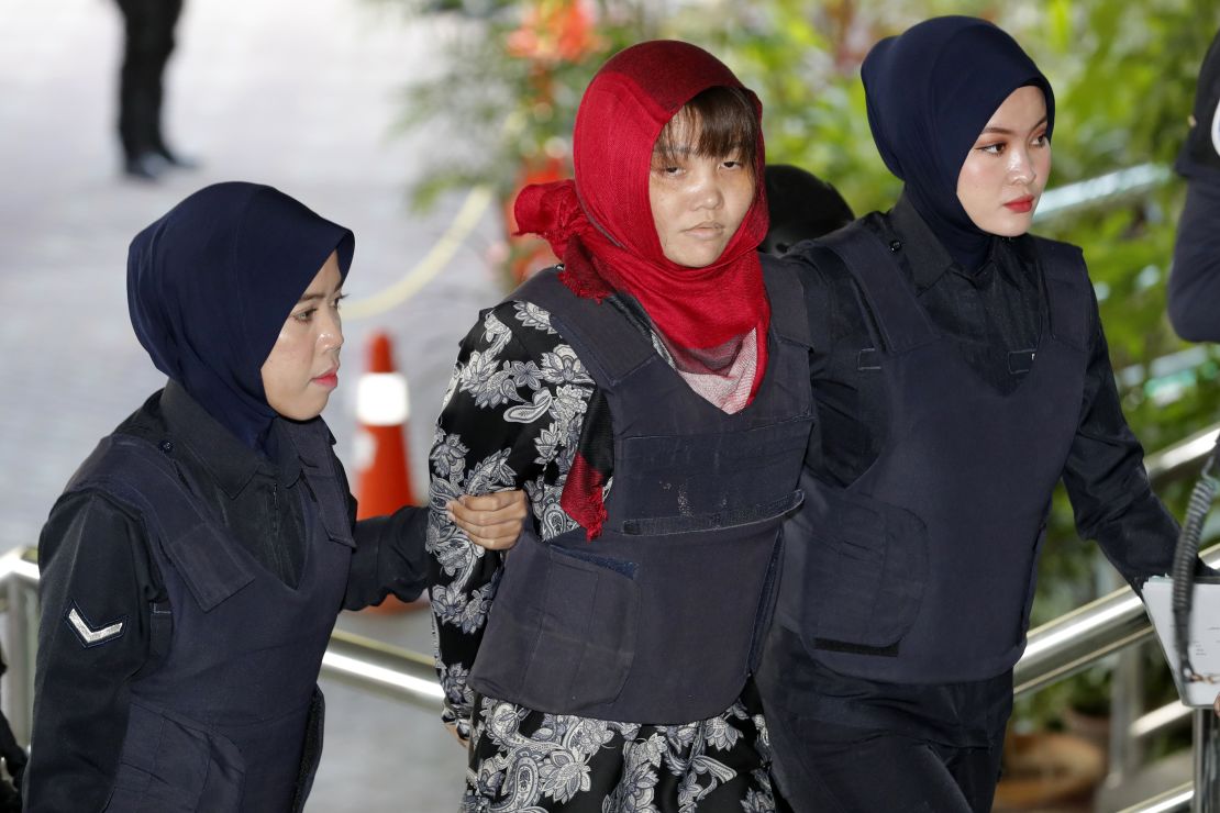 Vietnamese national Doan Thi Huong, center, is escorted by police as she arrives at Shah Alam High Court in Shah Alam, Malaysia, on Thursday.