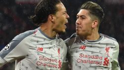 Liverpool's Dutch defender Virgil van Dijk celebrates scoring the 1-2 goal with his team-mate Brazilian midfielder Roberto Firmino (R) during the UEFA Champions League, last 16, second leg football match Bayern Munich v Liverpool in Munich, southern Germany, on March 13, 2019. (Photo by Christof Stache / AFP) / ALTERNATIVE CROP        (Photo credit should read CHRISTOF STACHE/AFP/Getty Images)