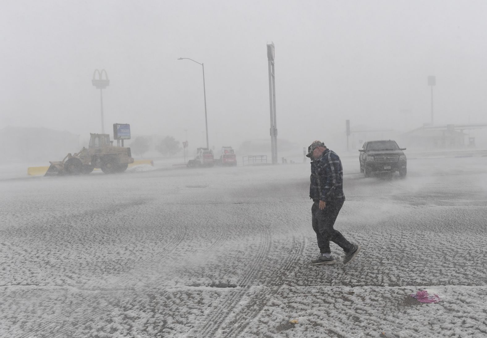 A truck driver heads back to his truck March 13 after eating at a restaurant in Limon, Colorado, where the storm stranded him.