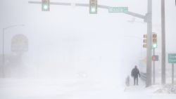 James Little crosses the street during a blizzard on Wednesday, March 13, 2019, in Cheyenne, Wyo.  Heavy snow hit Cheyenne about mid-morning Wednesday and was spreading into Colorado and Nebraska.  (Jacob Byk/The Wyoming Tribune Eagle via AP)