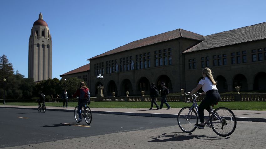 STANFORD, CA - MARCH 12: Cyclists ride by Hoover Tower on the Stanford University campus on March 12, 2019 in Stanford, California. More than 40 people, including actresses Lori Loughlin and Felicity Huffman, have been charged in a widespread elite college admission bribery scheme. Parents, ACT and SAT administrators and coaches at universities including Stanford, Georgetown, Yale, and the University of Southern California have been charged. (Photo by Justin Sullivan/Getty Images)