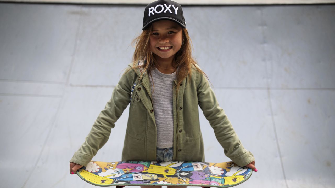 Sky Brown poses with a skateboard.