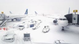 NEW YORK, NY - JANUARY 04:  JetBlue airplanes wait at the gates outside terminal five at John F. Kennedy International Airport on January 4, 2018 in the Queens borough of New York City. A winter storm is traveling up the east coast of the United States dumping snow and creating blizzard like conditions in many areas. (Photo by Rebecca Butala How/Getty Images)