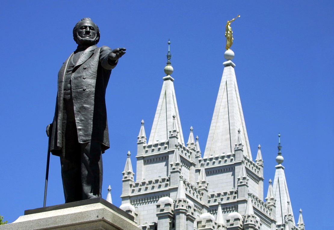 A statue of Brigham Young, second president of the Church of Jesus Christ of Latter Day Saints, stands in the center of Salt Lake City with the Mormon Temple spires in the background in 2001.