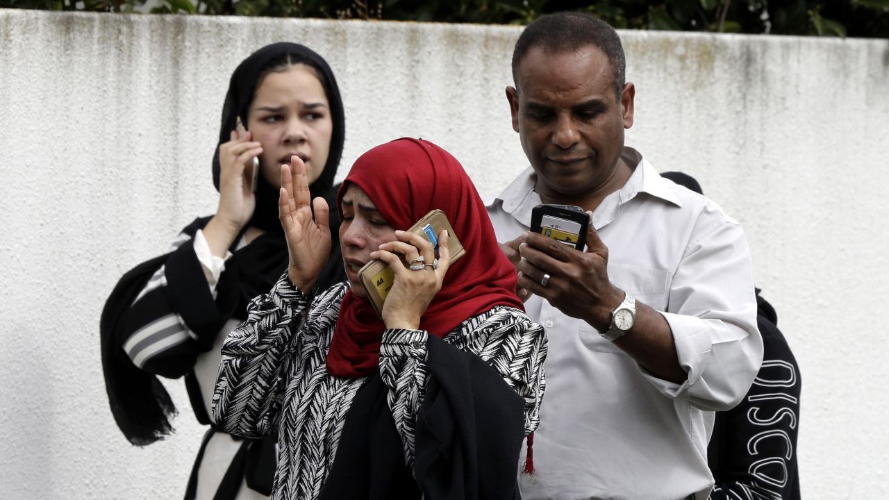 People wait outside a mosque in central Christchurch, New Zealand, Friday, March 15, 2019.