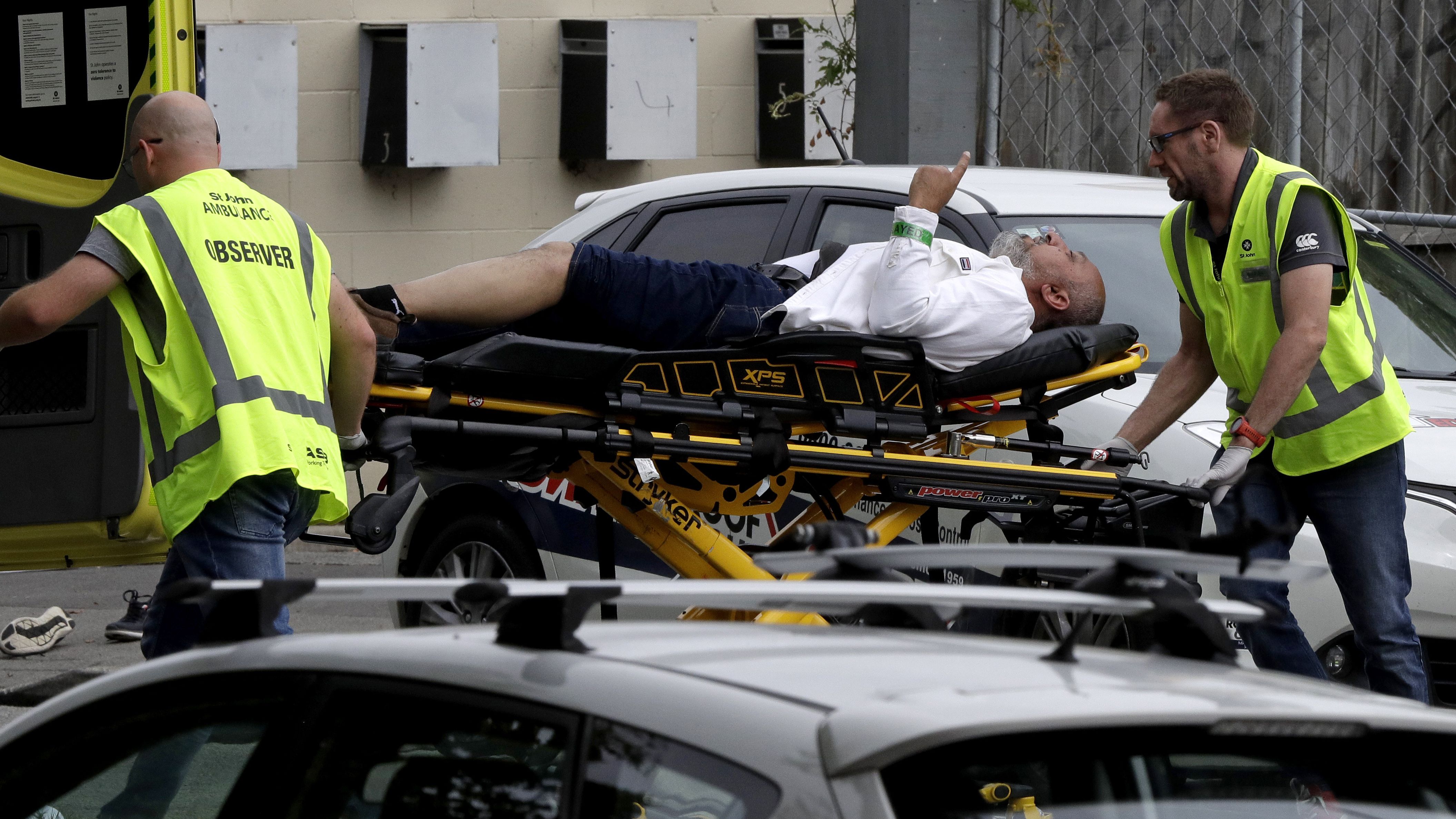 Paramedics load an injured man into an ambulance in Christchurch, New Zealand, on Friday, March 15.