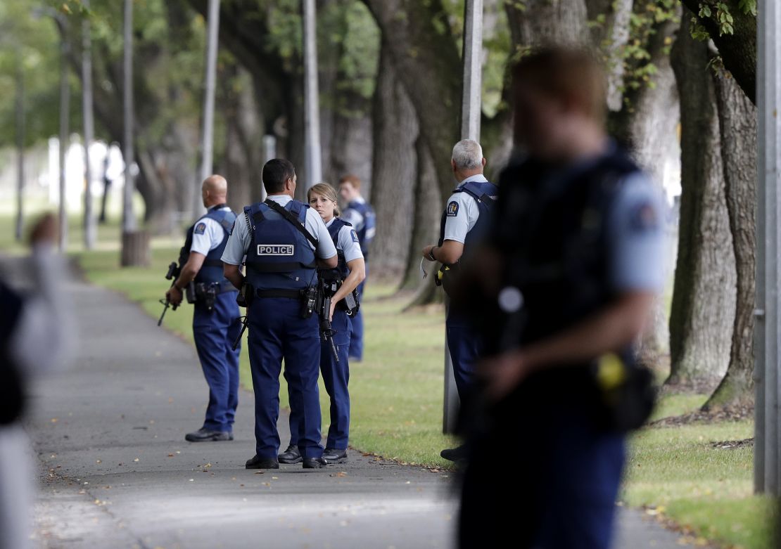 Police keep watch at a park near one of the mosques attacked on Friday.