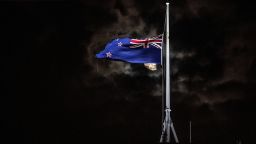 TOPSHOT - The New Zealand national flag is flown at half-mast on a Parliament building in Wellington on March 15, 2019, after a shooting incident in Christchurch. - Attacks on two Christchurch mosques left at least 49 dead on March 15, with one gunman -- identified as an Australian extremist -- apparently livestreaming the assault that triggered the lockdown of the New Zealand city. (Photo by Marty MELVILLE / AFP)        (Photo credit should read MARTY MELVILLE/AFP/Getty Images)