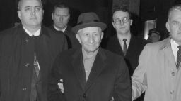 Flanked by FBI agents, Carlo Gambino, 67, reputed to be the Maria's "Boss of all Bosses," is led from FBI headquarters after he was arrested for plotting to rob the crew of an armored car containing six million dollars. The robbery never took place, a spokesman said. No other details except the owner of the truck, US Trucking Company, were released. Gambino, the FBI said, is one of the most powerful Mafioso in the US.