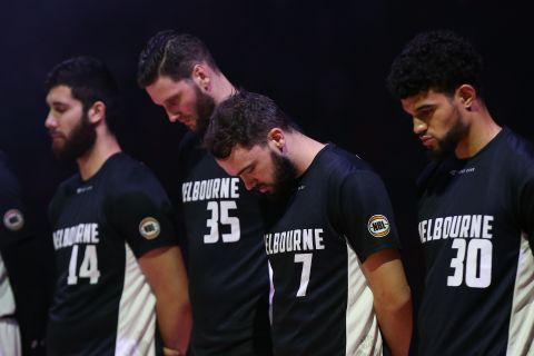 Players from the Australian basketball team Melbourne United observe a moment of silence before a game in Perth, Australia, on March 15.