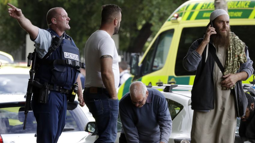 Police attempt to clear people from outside a mosque in central Christchurch, New Zealand, Friday, March 15, 2019. Many people were killed in a mass shooting at a mosque in the New Zealand city of Christchurch on Friday, a witness said. Police have not yet described the scale of the shooting but urged people in central Christchurch to stay indoors.(AP Photo/Mark Baker)