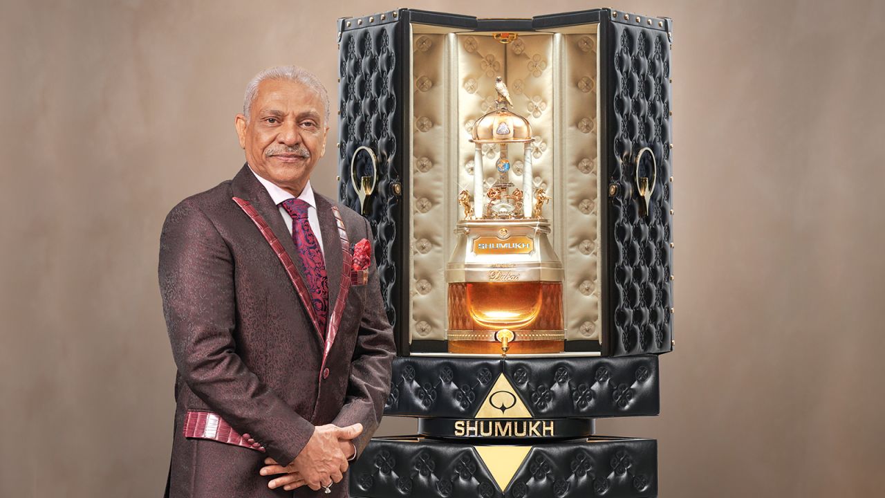 Founder and chairman of Nabeel Perfumes Group Asghar Adam Ali stands next to the $1.295 million bottle of "Shumukh."
