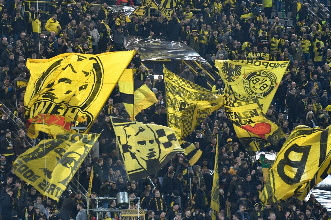 Dortmund fans wave flags ahead of a Champions League game.