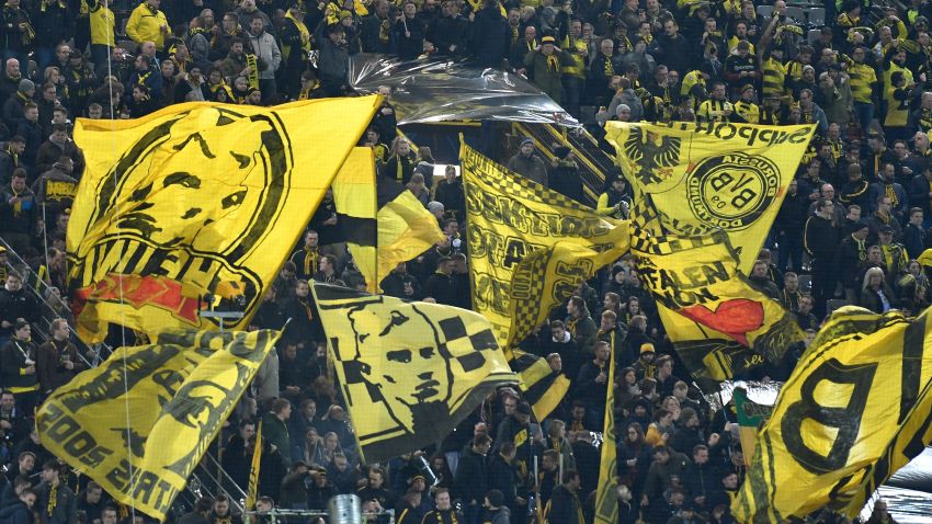 Dortmund fans wave flags prior to the UEFA Champions League round of 16 second leg football match between BVB Borussia Dortmund and Tottenham Hotspur on March 5, 2019 in Dortmund, western Germany. (Photo by John MACDOUGALL / AFP)        (Photo credit should read JOHN MACDOUGALL/AFP/Getty Images)