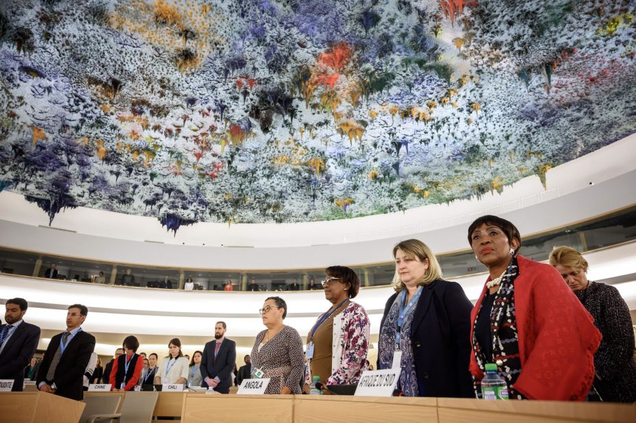 Delegates stand during a minute of silence that was observed at the United Nations Human Rights Council in Geneva, Switzerland.