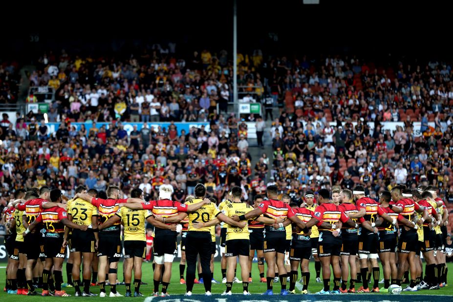 The Chiefs and Hurricanes gather together to remember the victims ahead of a professional rugby match in Hamilton, New Zealand.