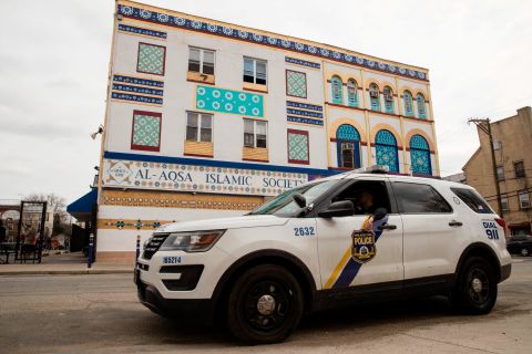 Police officers sit in their vehicle outside the Al Aqsa Islamic Society mosque in Philadelphia on March 15. Many cities bumped up their police presence outside of mosques.