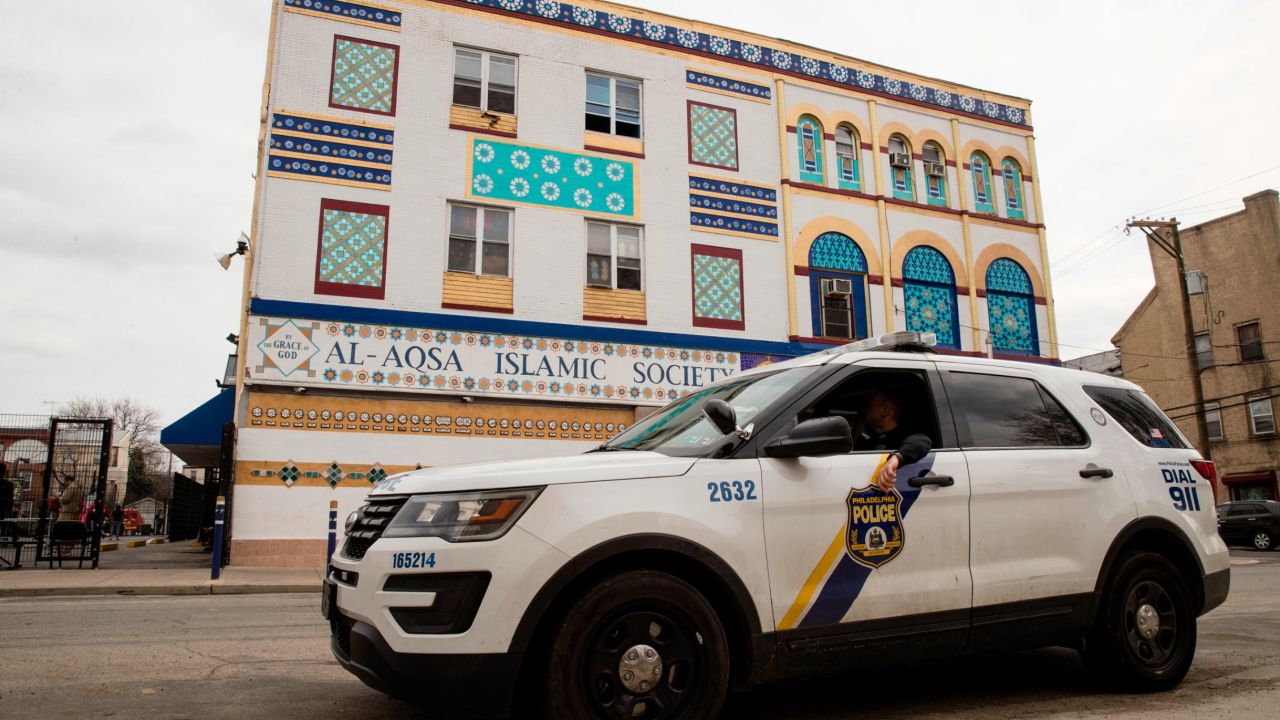 In the wake of the deadly attack against two mosques in New Zealand, police officers sit in their vehicle out side the Al Aqsa Islamic Society mosque in Philadelphia, ahead of prayers Friday, March 15, 2019. (AP Photo/Matt Rourke)