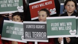 Young demonstrators hold banners from multi-faith group 'Turn to Love' during a vigil at New Zealand House in London, Friday, March 15, 2019. Multiple people were killed in mass shootings at two mosques full of worshippers attending Friday prayers on what the prime minister called "one of New Zealand's darkest days," as authorities detained four people and defused explosive devices in what appeared to be a carefully planned attack. (AP Photo/Kirsty Wigglesworth)