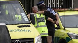 Police and ambulance staff help a wounded man from outside a mosque in central Christchurch, New Zealand, Friday, March 15, 2019.  A witness says many people have been killed in a mass shooting at a mosque in the New Zealand city of Christchurch. (AP Photo/Mark Baker)