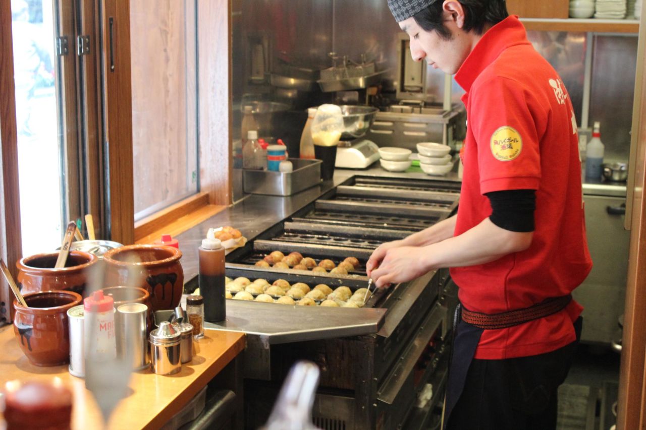 A chef in Tokyo's Akasaka district prepares takoyaki -- deep-fried octopus balls. 