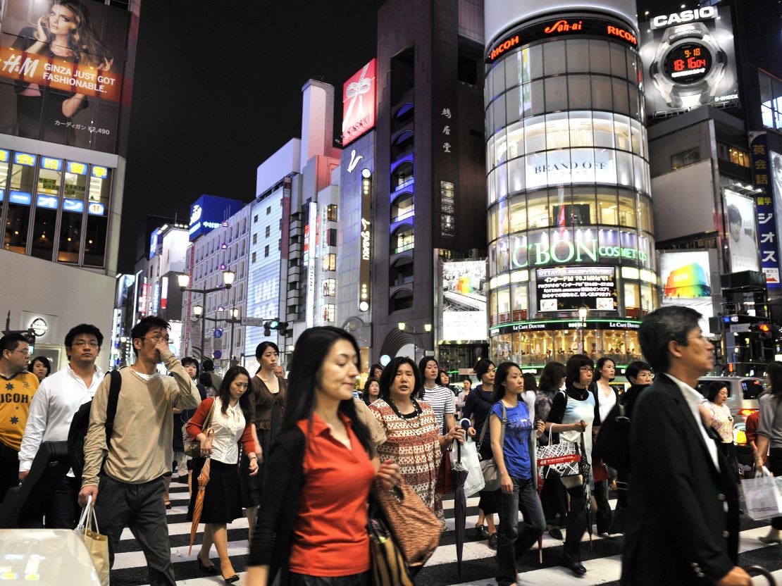 Pedestrians cross an intersection in Tokyo's Ginza district