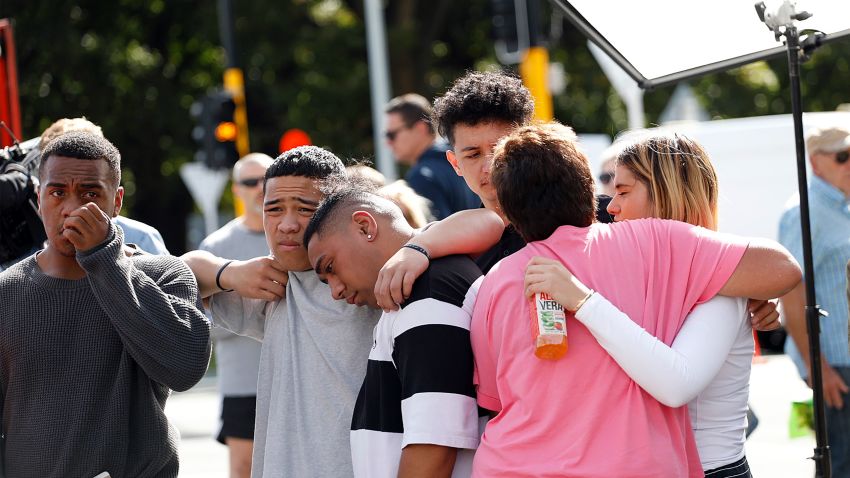 Residents get emotional as they pay respect by placing flowers for the victims of the mosques attacks in Christchurch on March 16, 2019. - New Zealand's prime minister vowed to toughen the country's gun laws after revealing Saturday that the man accused of murdering 49 people in two mosques legally purchased the arsenal of firearms used in the massacre. Jacinda Ardern said the gunman, 28-year-old Australian Brenton Tarrant, obtained a "Category A" gun licence in November 2017 and began purchasing the five weapons used in Friday's attacks in the southern city of Christchurch the following month. (Photo by Tessa BURROWS / AFP)        (Photo credit should read TESSA BURROWS/AFP/Getty Images)