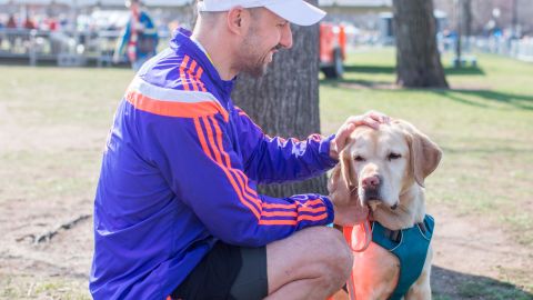 Thomas Panek completes the 2018 BAA 5K in Boston, led by his guide dog Gus. 