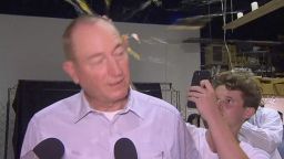 In this image made from video, a teenager breaks an egg on the head of Senator Fraser Anning while he holds a press conference, Saturday, March 16, 2019, in Melbourne, New Zealand. Following the mass shootings on Friday, Anning came under sharp criticism over tweets including one that said: "Does anyone still dispute the link between Muslim immigration and violence?" (AP Photo)