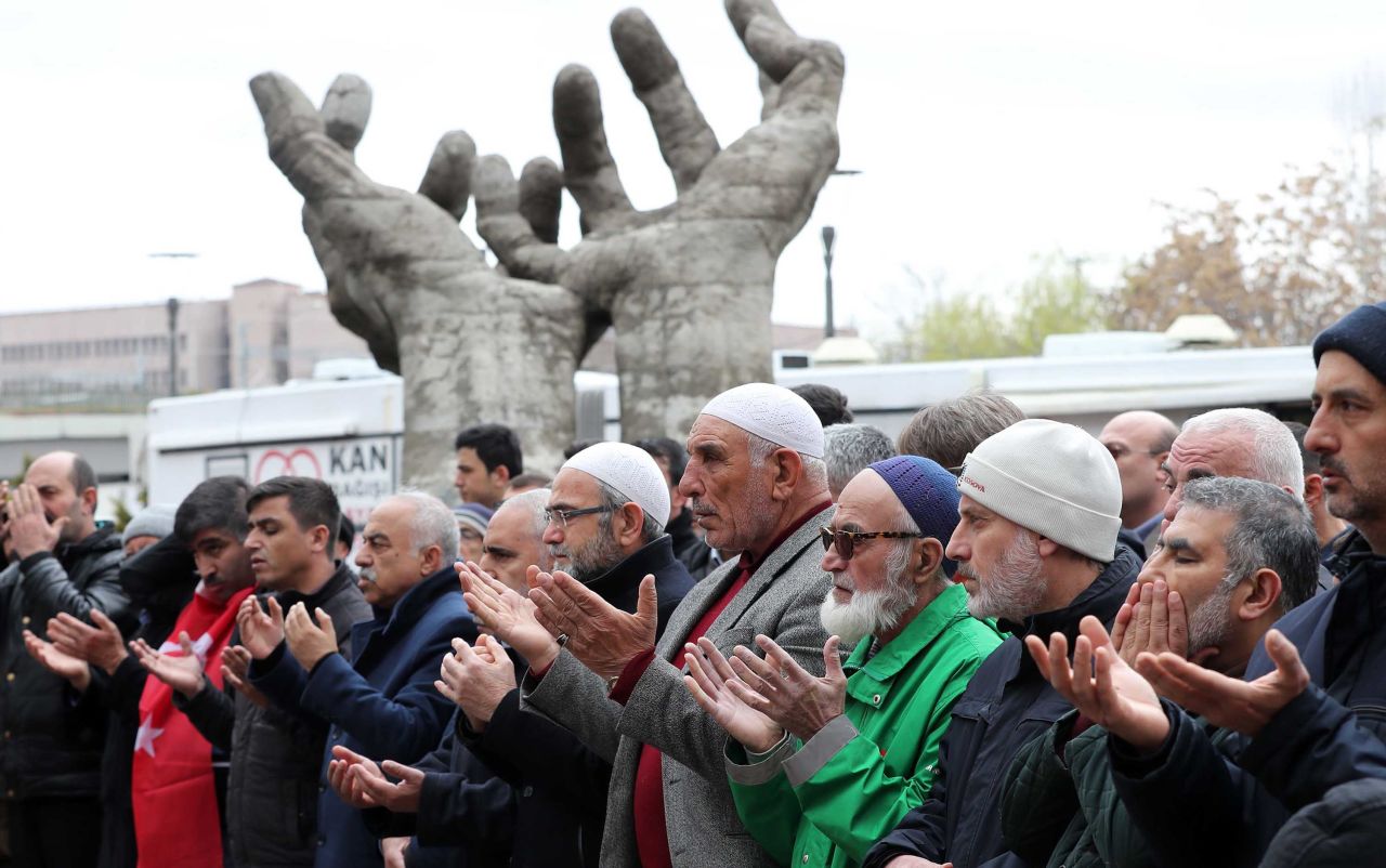 People perform a funeral prayer in absentia on March 16 in Ankara, Turkey.