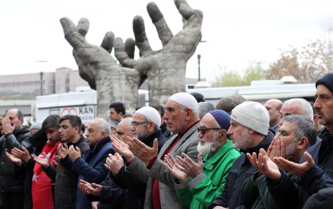 People perform a funeral prayer in absentia on March 16 in Ankara, Turkey. 