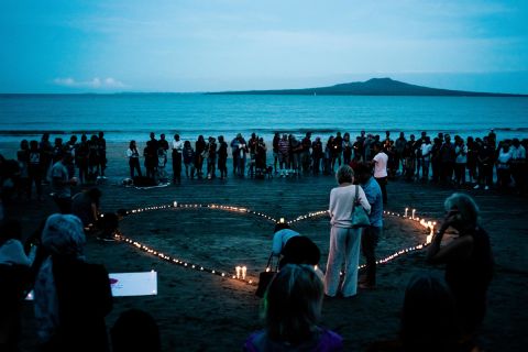 Crowds gather on Takapuna Beach in Auckland, New Zealand, on March 16 for a vigil for the victims of the Christchurch attacks.