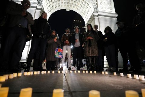 People hold a vigil at Washington Square Park in New York on March 16.