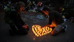 CHRISTCHURCH, NEW ZEALAND - MARCH 17: People light candles next to flowers and tributes laid by the wall of the Botanic Gardens on March 17, 2019 in Christchurch, New Zealand. 50 people are confirmed dead, with 36 injured still in hospital following shooting attacks on two mosques in Christchurch on Friday, 15 March. 41 of the victims were killed at Al Noor mosque on Deans Avenue and seven died at Linwood mosque. Another victim died later in Christchurch hospital. A 28-year-old Australian-born man, Brenton Tarrant, appeared in Christchurch District Court on Saturday charged with murder. The attack is the worst mass shooting in New Zealand's history. (Photo by Carl Court/Getty Images)