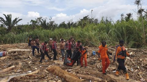 A photo from Indonesia's National Search and Rescue Agency (BASARNAS) shows the agency's personnel and police carrying the body of flood victim in Indonesia's Papua province on Sunday.