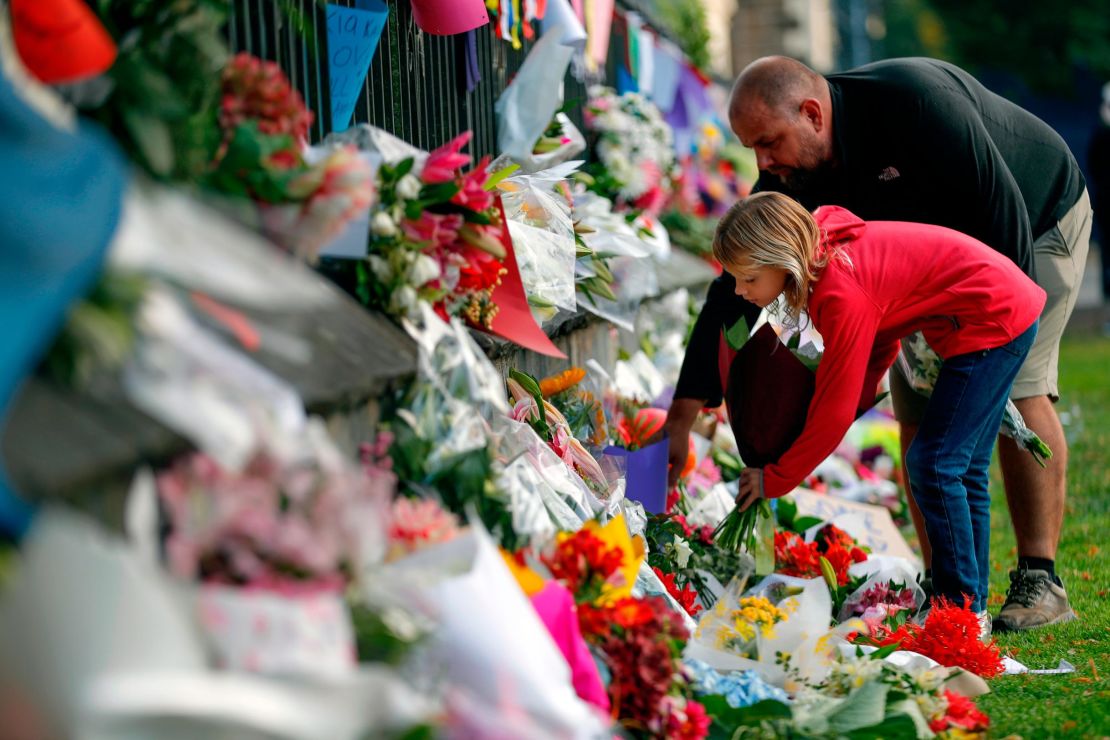 Mourners lay flowers on a wall at the Botanical Gardens in Christchurch on Saturday.