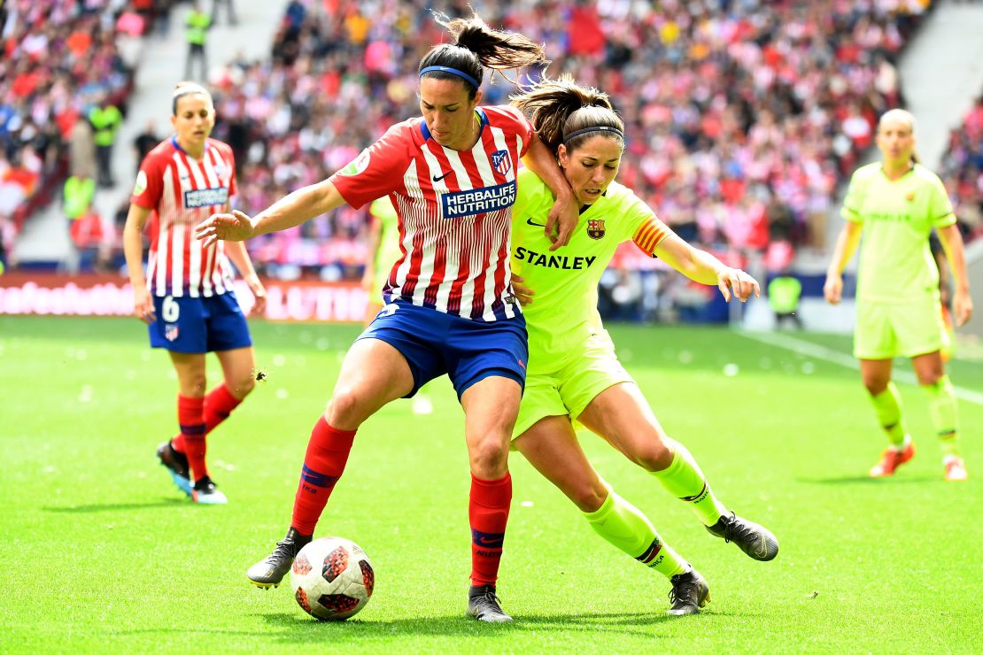 Atletico Madrid's midfielder Silvia Meseguer (left) tussles with Barcelona FC's midfielder Vicky Losada.