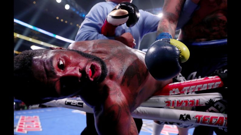 Jean Pierre Augustin falls out of the ring after being hit by Chris Arreola during a Premier Boxing Champions Heavyweight Bout at AT&T Stadium in Arlington, Texas, on Saturday, March 16.