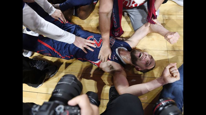 Jordan Ford of the Saint Mary's Gaels is mobbed by teammates and media on the court after the Gaels defeated the Gonzaga Bulldogs 60-47 to win the championship game of the West Coast Conference basketball tournament at the Orleans Arena in Las Vegas on Tuesday, March 12.