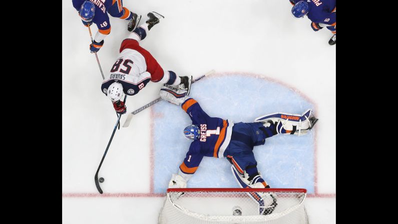 Thomas Greiss, right, of the New York Islanders makes a second-period save on David Savard of the Columbus Blue Jackets at the NYCB Live's Nassau Coliseum in Uniondale, New York, on Monday, March 11.