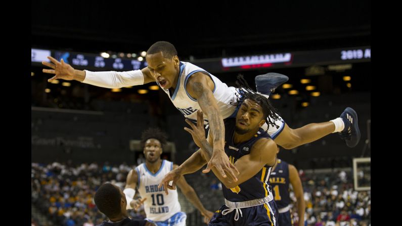 Fatts Russell, top, of the Rhode Island Rams goes up for a shot against Pookie Powell of the La Salle Explorers during the second round of the Atlantic 10 2019 tournament at the Barclays Center in Brooklyn, New York, on Thursday, March 14.
