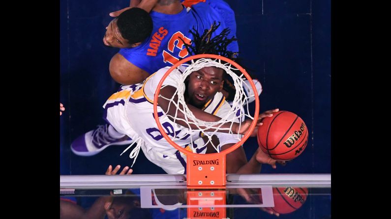 LSU Tigers forward Naz Reid puts in a rebound behind pressure from Florida Gators center Kevarrius Hayes in the SEC conference tournament at Bridgestone Arena in Nashville on Friday, March 15.