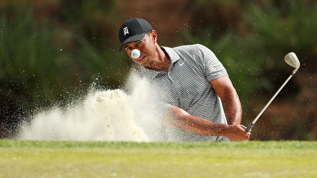 Tiger Woods of the United States plays a shot on the seventh hole during a practice round for The Players Championship on The Stadium Course at TPC Sawgrass in Ponte Vedra Beach, Florida, on Wednesday, March 13.