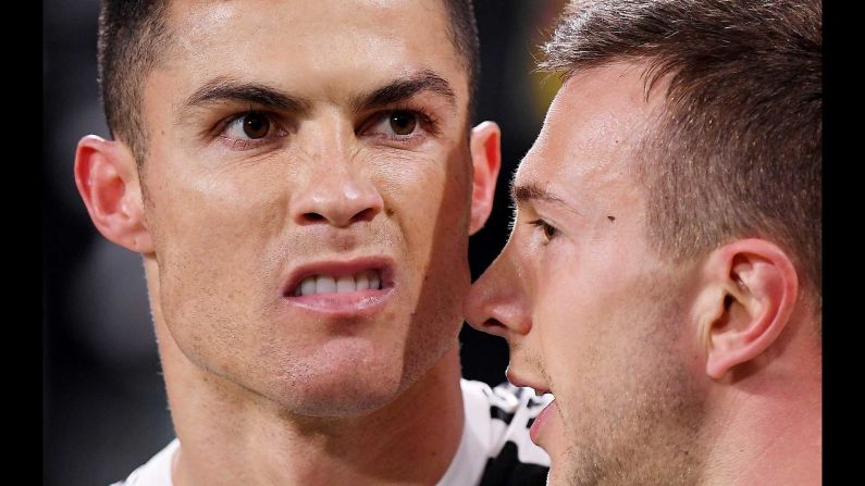 Juventus' Cristiano Ronaldo, left, celebrates scoring their third goal to complete his hat-trick with Federico Bernardeschi during a match between Juventus and Atletico Madrid at Allianz Stadium in Turin, Italy, on Tuesday, March 12.